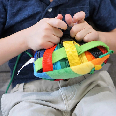 Child playing with Colorful Buckle Pillow Sensory Toy For Fine Motor Development And Kid Friendly Hands On OT Therapy