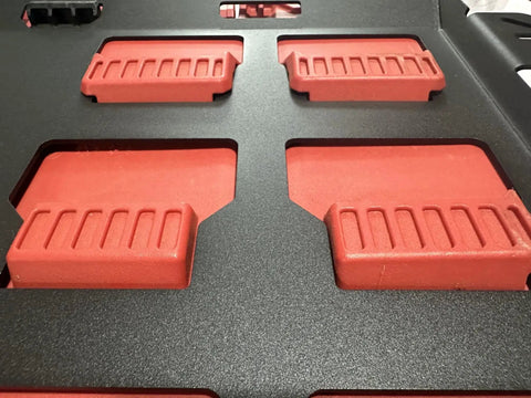 Close-up of Milwaukee Packout Wall Mounting Plate Dope Metal Base for Toolboxes Built Tough. Visible red brackets, rugged surface.