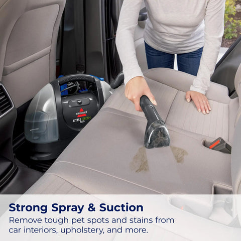 Person using Little Green Plus Portable Carpet Cleaner For Carpet And Upholstery With Stain Brush And Self Cleaning Hydrorinse 15 Foot Cord Powerful Spray And Suction For Quick Cleanups on car seat.