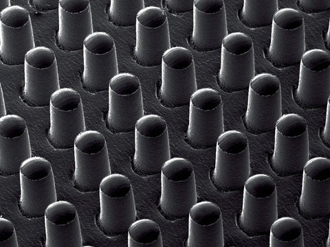 Close-up of GM630 Gripping Material Roll 24 Inch By 72 Yard Grey With Nylon Backing, showing textured thermoplastic elastomer surface.