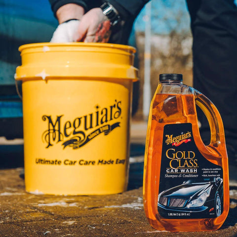 One Step Car Wash And Conditioner That Cleans And Conditions Without Stripping Wax And Foams Away Dirt And Road Grime While Preserving Wax Protection For A Dope Shine Meguiar's Gold Class 1.89L with bucket in background.