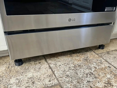 Front view of a range with Beefy Non Slip Range Foot Extension Risers Two Pack Height Boost Three Quarters Inch Front Feet installed