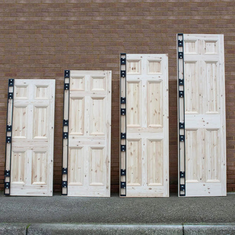 Four wooden doors of varying sizes with hinge placements, showing use of Butt Hinge Template Kit With Fully Adjustable Router Jig DIY Friendly.