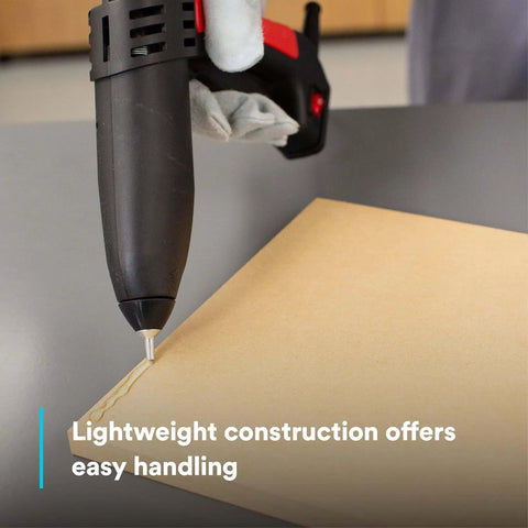 Single-unit industrial hot-melt applicator TC/TC-Q GEN II applying adhesive on cardboard surface