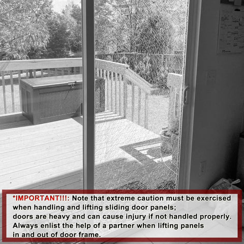 Cracked glass sliding patio door with caution notice, wooden deck visible outside