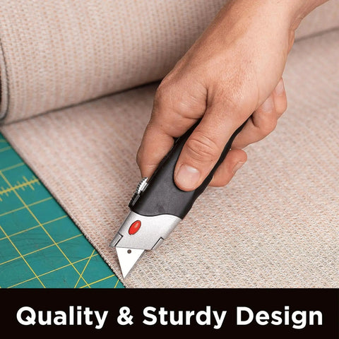 Hand holding Heavy Duty Utility Knife Set With Retractable Box Cutter And Rubber Handle, cutting carpet, showcasing metal body.