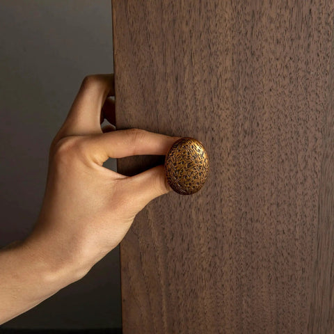 Close-up of hand installing antique brass zinc alloy drawer knob, Six Pack Zinc Alloy Drawer Knobs In Big Oval Antique Brass Finish