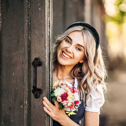 Beefy Heavy Duty Barn Door Handles Set Of 2 Black Rustic Cast Iron Gate Handles For Farmhouse Decor Sliding Doors With Hardware Large 9 Inch Indoor And Outdoor Use Pre Drilled Holes installed on a wooden door with a woman holding flowers.