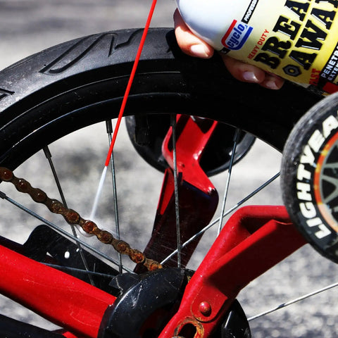 Applying Heavy Duty Breakaway Penetrating Oil For Loosening Rusted Joints And Bolts to a rusted bicycle chain and wheel