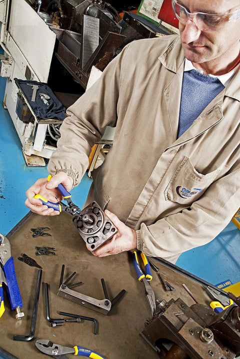 Mechanic using Convertible Snap Ring Pliers Six Point Five Inch With Four Interchangeable Tips for Internal and External Use