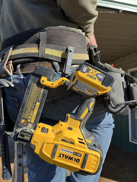 Universal Tool Holder Belt Hook For Cordless Drills Saws And More in use on tool belt, holding a yellow drill, outdoors