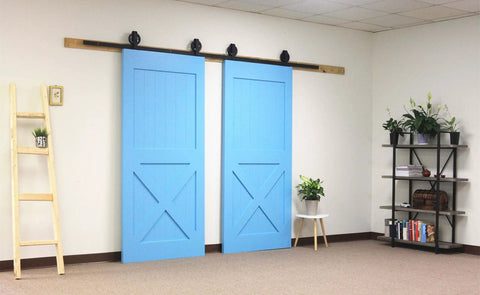 Black Rustic Non-Bypass Sliding Barn Door Hardware Kit For Two Doors With 16Ft Long Flat Track installed in a room.