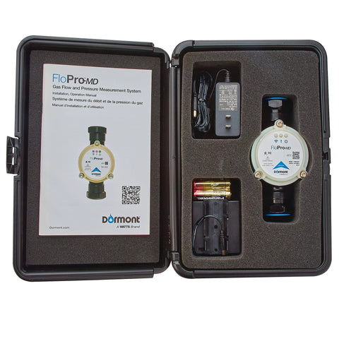 Dormont Flo-Pro MD gas flow and pressure diagnostic tool in a case; white circular device with blue label, AC adapter, 4-AA battery pack.
