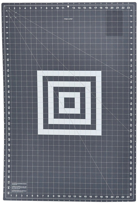 Ultra Large Self Healing Cutting Mat For Quilting And Crafts 24 By 36 Grid Surface With Double Sided Self Healing Layer And Clear Easy Read Grids For Precise Fabric Cuts And Long Strip Work Fiskars, gray mat showing full grid design.