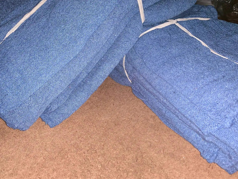 Stacks of blue shop towels for mechanics and auto maintenance 14 by 14 inch 1000 sheets box grade B grease and oil wipes heavy duty.