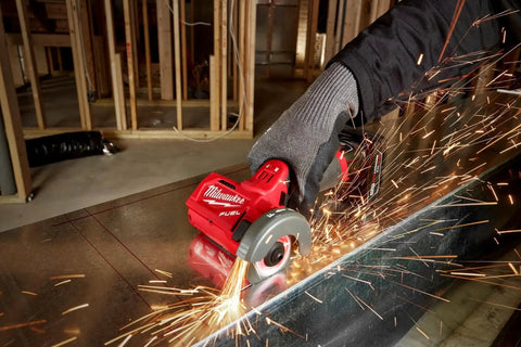 Compact 12V Cut Off Tool Bare Tool With Reversible Blade Rotation in use cutting metal with sparks flying.