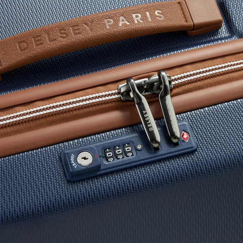 Close-up of Chatelet Air 2.0 Hardside Luggage Trunk With Spinner Wheels Navy Blue 26 Inch with TSA lock and faux leather accents by Delsey Paris.