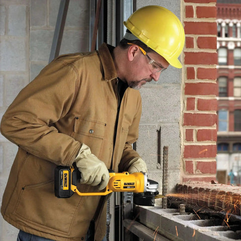 Worker using Cordless 4-1/2 Inch Angle Grinder With 8,000 RPM Motor, Quick-Change Wheel Release, Tool Free Guard, And 20V Max Power From DEWALT DCG412B Tool Only on metal surface at construction site