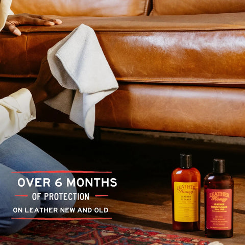 Person using a cloth to clean leather furniture near Premium Leather Conditioner That Restores All Leather Items From Auto To Furniture And Shoes Purses And Tack Non Toxic Made In USA 8 Fl Oz Leather Honey bottles.