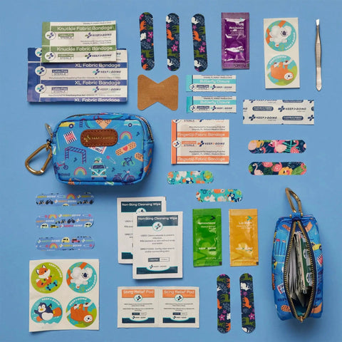 Compact Travel First Aid Kit For Kids With Sixty-Piece Set And Latex-Free Bandages displayed with its contents on a blue background.
