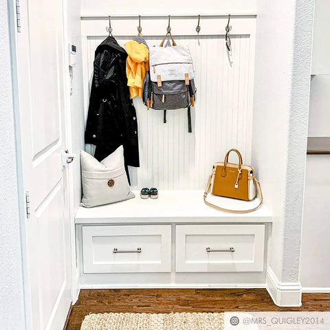 Entryway with Milano Door And Drawer Pull 8 Inch Center-To-Center in Oil Rubbed Bronze on white drawers under coat and bag rack