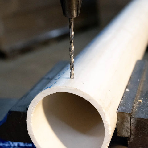 Premium High Speed Steel Wire Gauge Drill Bit No 44 drilling a hole in a PVC pipe, showcasing bright polished finish and precision.