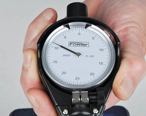 Close-up of Dial Bore Gage Set With 0.7 To 1.5 Inch Range, 0.0005 Inch Dial Readout, 8 Inch Measuring Depth, held by a hand
