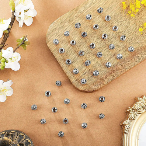 60 Pieces Dope Silver Tone Filigree Spacer Beads Set Hollow Tibetan Alloy Beads In 10 Styles 10 Mm Tiny Metal Beads displayed