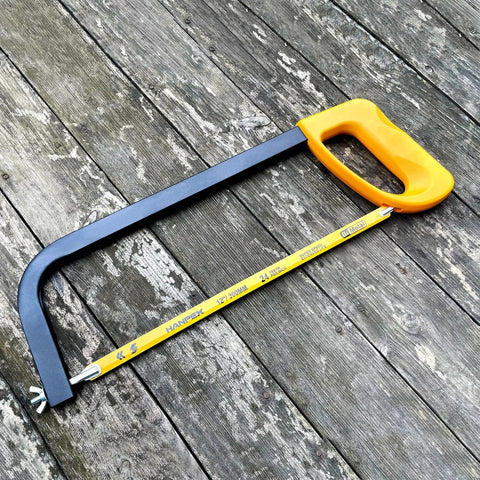 High Tension 12 Inch Hacksaw Frame With 24 TPI Bi Metal Blade For Metal Wood And PVC Carpentry Pro Grade With Adjustable Tension And Comfortable Non Slip Grip Hanpex on wooden surface