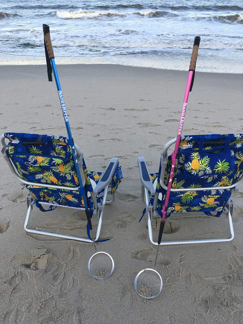 Beach Dipper Sifter Shovel for Beachcombing with 6 Inch Basket and adjustable walking stick, blue and pink, leaning on beach chairs