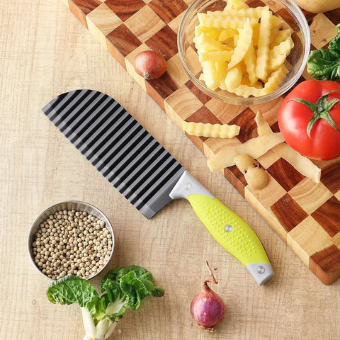 Crinkle Cutter And Wave Fries Maker for veggies with non-slip handle on wooden board, alongside sliced potatoes and vegetables.