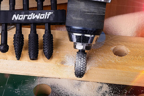Pro Grade 10-Piece Rotary Burr Wood Carving Rasp Files Set With One Quarter Inch Hex Shank For Wood Deburring, Shaping And Grooving NordWolf High Carbon Steel Construction For Tight, Precise Work being used on wood.