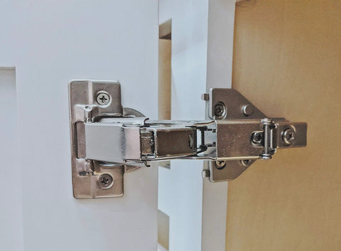 165 Degree Soft Close Cabinet Hinge For Inner Folding Corner Doors installed on kitchen cabinet, showing frame-to-door connection.