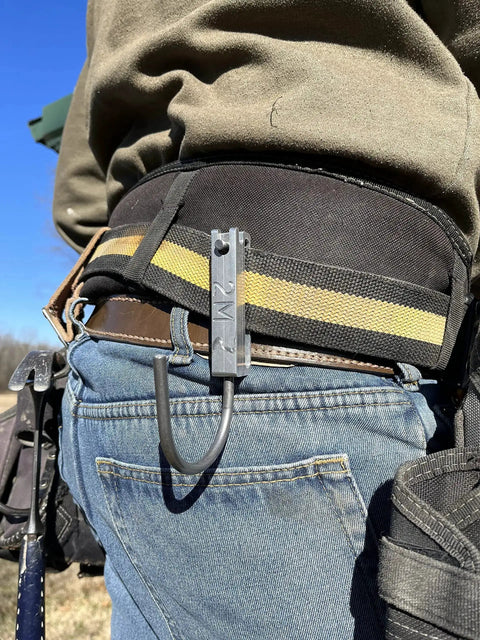 Universal Tool Holder Belt Hook for cordless drills shown on a worker's belt, made in USA, left or right hand use, CNC aluminum design.