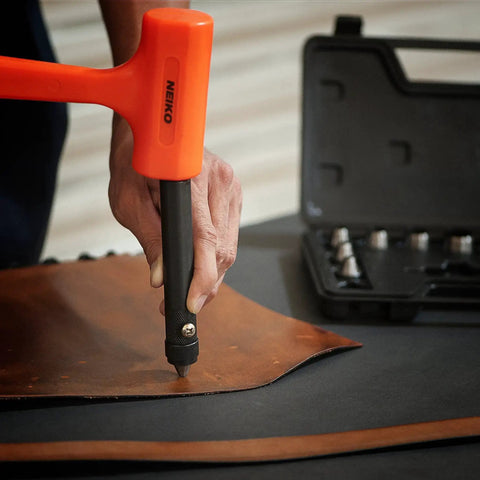 Using the Interchangeable Large Hollow Hole Punch Tool Set on leather, showcasing precise steel punches, pilot tip drive handle, and case.