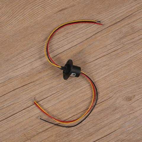 High Current Slip Ring Rotating Connector With 3 Wires 10A 22Mm Diameter, shown with colored wires on a wooden surface