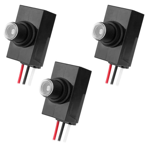 Three black 3-Pack Dusk To Dawn Outdoor Lighting Sensor, 100-277V Weatherproof Photocell Switch shown from various angles.