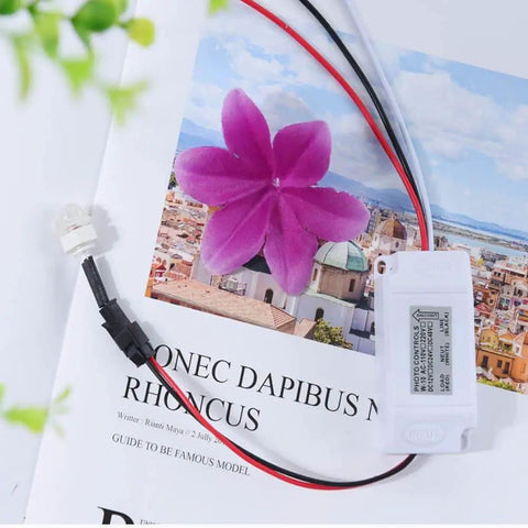Close-up of Outdoor Photocell Sensor Switch Dusk To Dawn Light Control IP44 Weatherproof Rainproof with purple flower on brochure