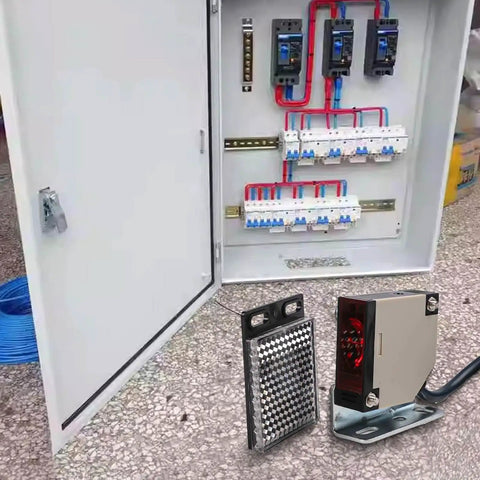 Reflector Photoelectric Sensor Switch with Infrared Beam Detection shown in front of electrical panel, 4 Meter Sensing Range, NO/NC Relay.