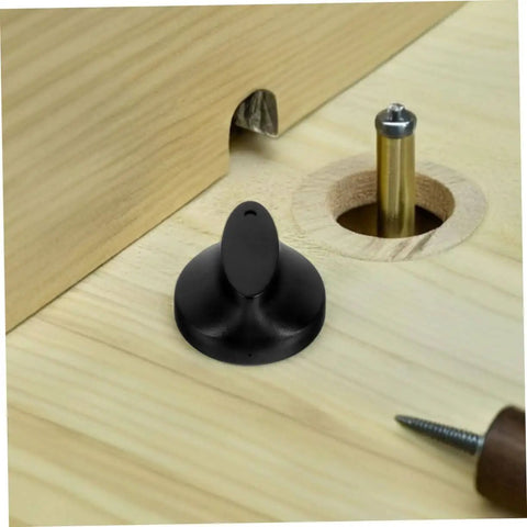 Black plastic Universal Timer Knobs Replacement for ovens, sterilizers, and rice cookers with precise timing, shown on wooden surface