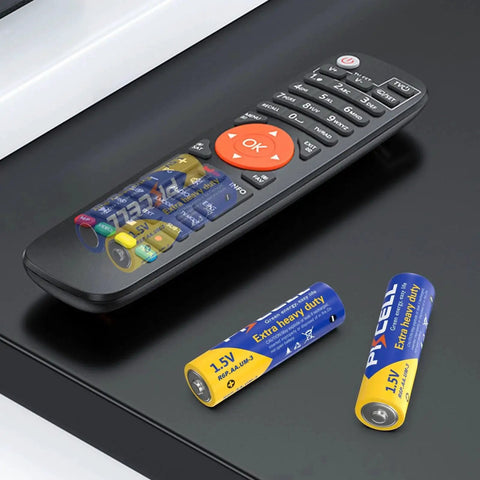 Remote control with AA and AAA Battery Combo Pack 80 Count 1.5V Carbon Zinc High Energy Batteries on a black surface.