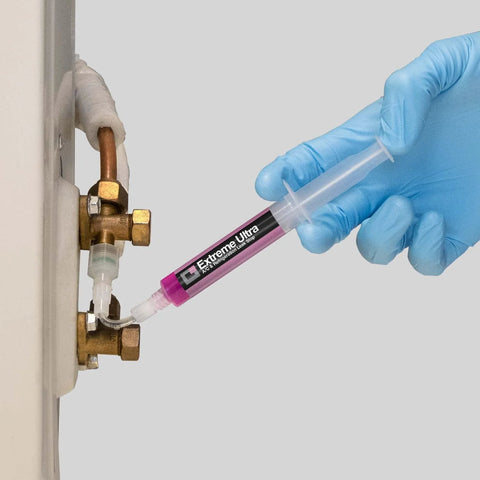 ERRECOM Extreme Ultra A/C leak stop cartridge being applied to HVAC valve; pink label, brass fittings, adapters visible