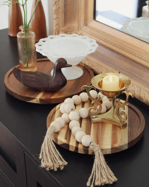Acacia Wood Lazy Susan Turntable 10 Inch for tabletop organization, featuring natural grain patterns with decorative items on it.