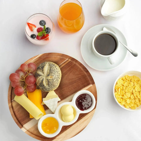 Breakfast setup with Acacia Wood Lazy Susan Turntable Organizer 8-Inch Round Rotating Serving Tray holding cheese, bread, and jam.