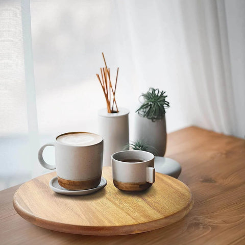 18 inch acacia wood lazy susan cabinet organizer with coffee cups and decorative vases on a wooden table.