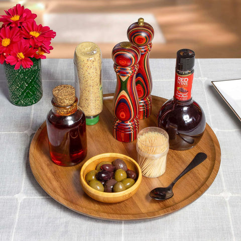 Acacia wood lazy susan organizer designed for kitchen and pantry use, featuring condiments and olives on a wooden turntable.