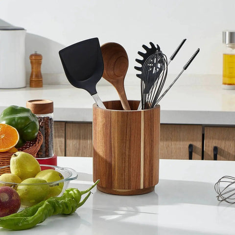 Acacia Wood Utensil Holder For Kitchen Countertop With 360 Degree Rotating Base overflows with cooking tools in a farmhouse kitchen.