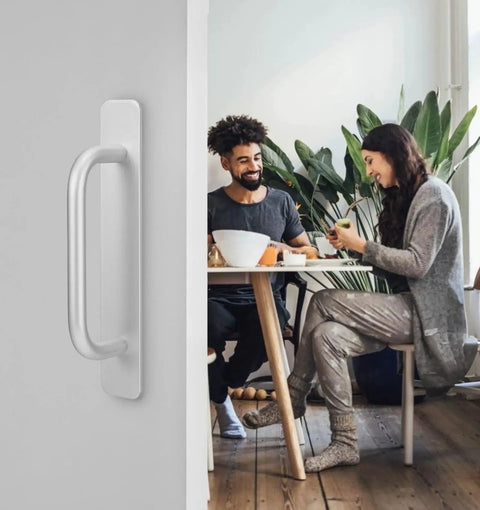 Adhesive Cabinet Handles 2 Pack 5.8 Inch No Drill Push Pull Self Stick Installation silver handle on a door with people dining in background.