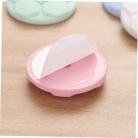 Close-up of one pink bumper pad from Five Pack Washing Machine Door Bumpers With Strong Adhesive Protective Pads For Washer Leveling And Wall Protection, Cushions That Stick Like Crazy And Help Prevent Wall Dings, Works With Most Front Load And Top Load Machines, Random Color, showing adhesive side.