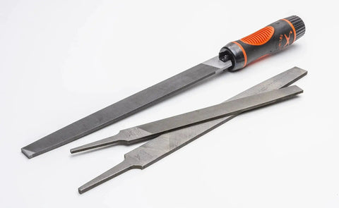Adjustable universal file handle clamps to tool tang and fits multiple file sizes without inserts with metal files on a white background.